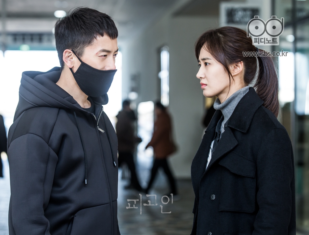 심각한 표정의 권유리와 검은옷에 검은 마스크를 쓴 지성의 옆모습